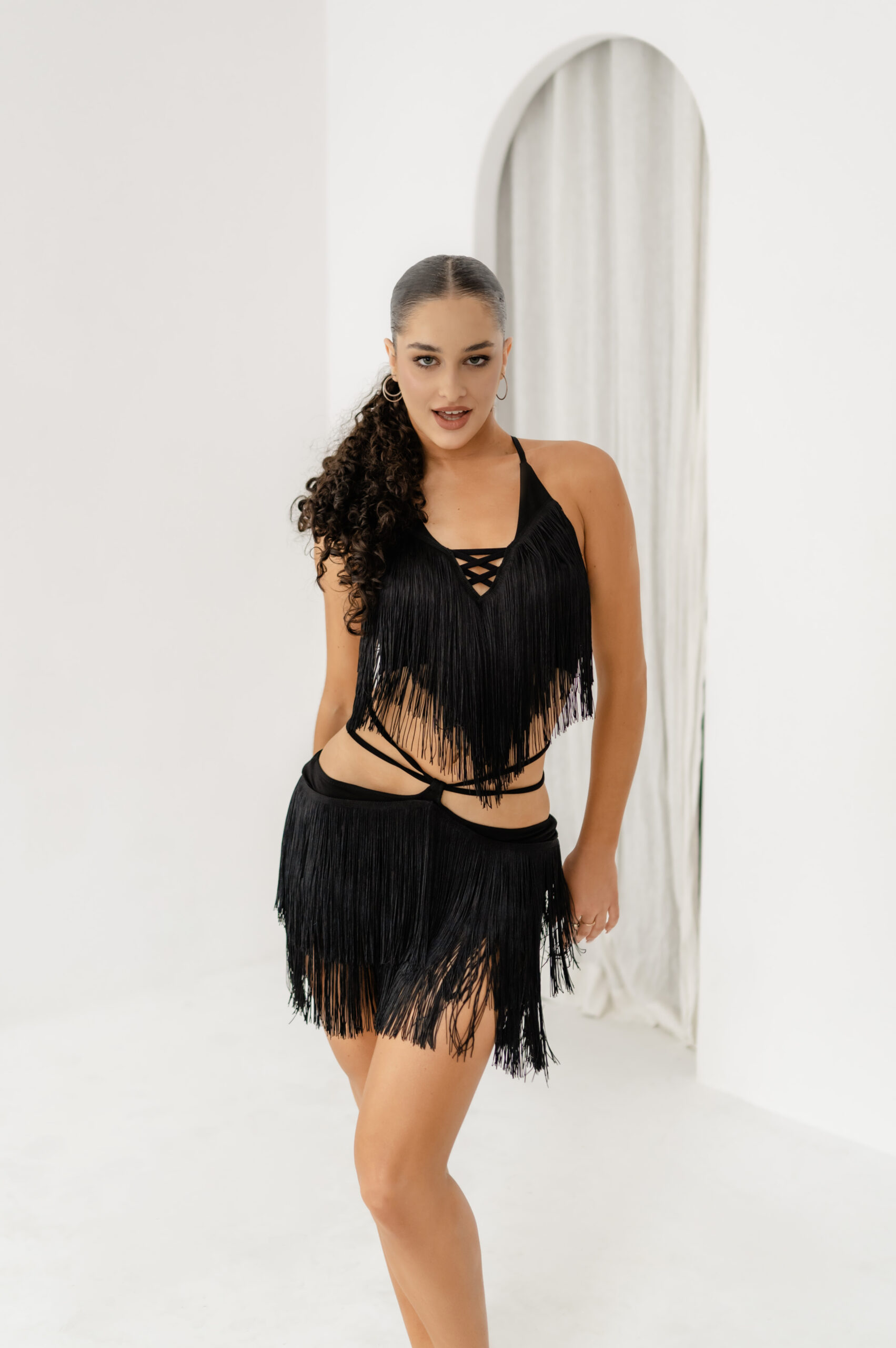 Stylish Latin skirt with fringes, available in black, white, leopard print, and red, offering elegance and comfort for Latin dance performances.