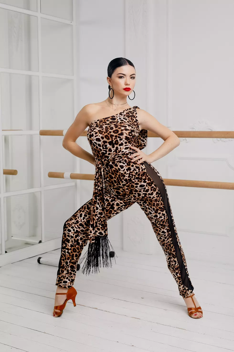 Latin dance jumpsuit with leopard print and transparent mesh inserts.