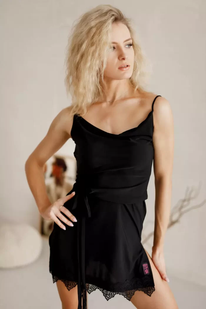 Short black Latin-style dress with straps, deep V-neckline, open back, and a fringed belt.