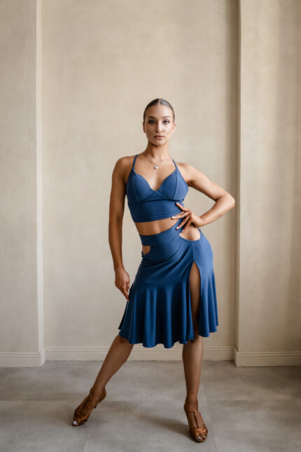 Latin dance skirt with side cutouts and flowing ruffles, featuring built-in panties for comfort.